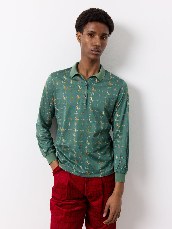 This Christian Dior shirt features illustrated golf club designs on a vintage sports shirt. It has a half button and polo shirt style and long sleeves.