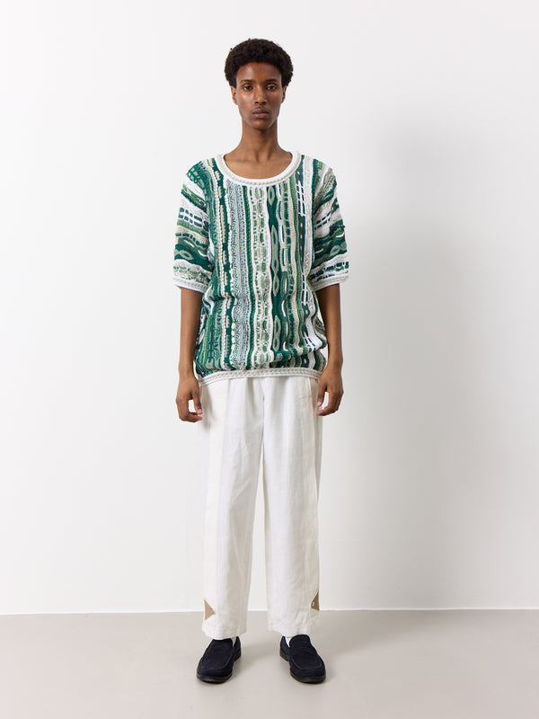 Experience the luxurious feel of Coogi's top-quality cotton fabric. The weight of this piece is noticeable, and the unique white and green design adds to the overall flattering shape. This shirt is truly one-of-a-kind.