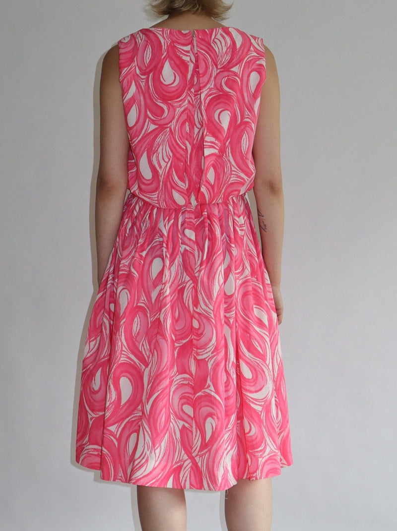 Beautiful soft pink swirl summer dress. Zipped back, lined, with a pleated skirt.  All the items we sell are authentic vintage and one-of-a-kind. You will receive the exact item photographed.  Best fits women: small