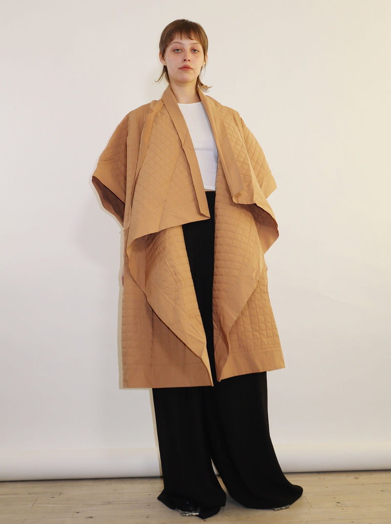Oversized full-length coat. Full quilted kimono-style coat. Soft fold-over front with front ribbon ties. Made with organic cotton.
